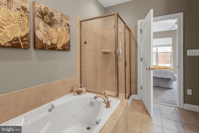 3911 Fleet St, Baltimore, MD 21224 - ensuite bathroom with a garden tub, a shower stall, tile patterned flooring, and baseboards