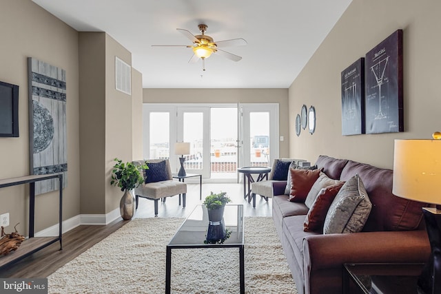 3911 Fleet St, Baltimore, MD 21224 - living room featuring a ceiling fan, wood finished floors, and baseboards