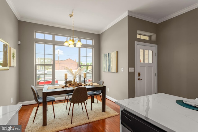 3911 Fleet St, Baltimore, MD 21224 - dining room with a chandelier, ornamental molding, dark wood-style flooring, and baseboards