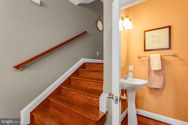 3911 Fleet St, Baltimore, MD 21224 - staircase featuring baseboards, wood finished floors, and crown molding