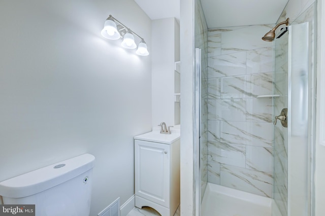 full bath with a marble finish shower, toilet, and vanity