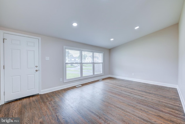 unfurnished living room with baseboards, wood finished floors, and recessed lighting