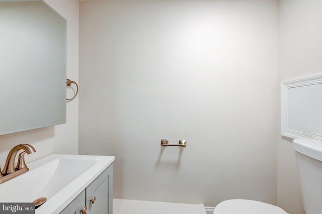 half bath featuring toilet and vanity