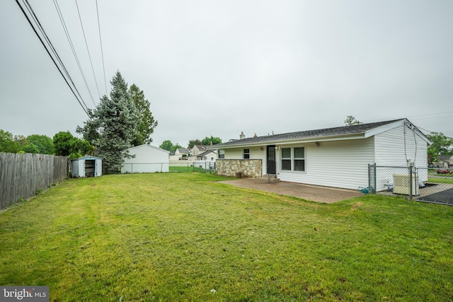 back of property with a storage unit, a patio area, and an outdoor structure