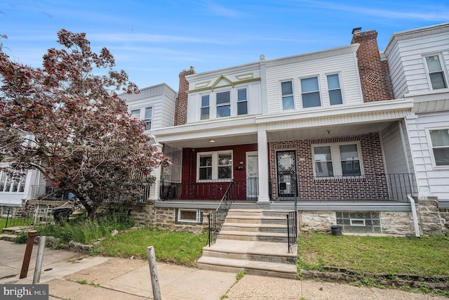 128 Linton St, Philadelphia, PA 19120 - view of property featuring covered porch and brick siding