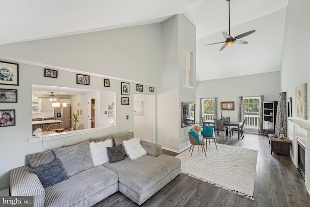 living room with high vaulted ceiling, ceiling fan, wood finished floors, and baseboards