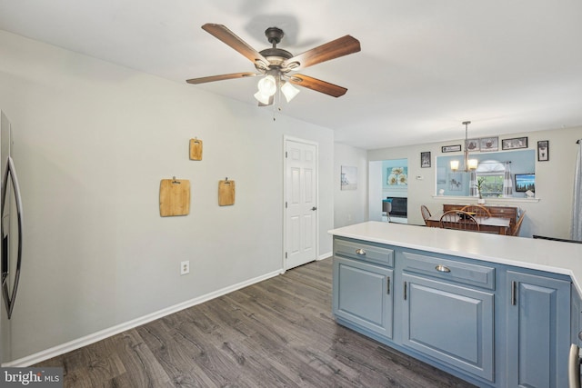 kitchen with dark wood-style flooring, ceiling fan, light countertops, and blue cabinets