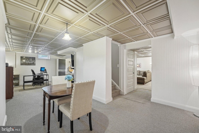 dining space featuring an ornate ceiling, carpet flooring, baseboards, an office area, and stairs