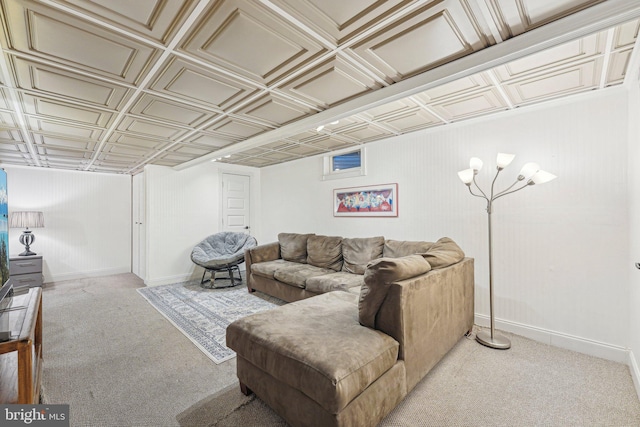 living room featuring an ornate ceiling, carpet flooring, and baseboards