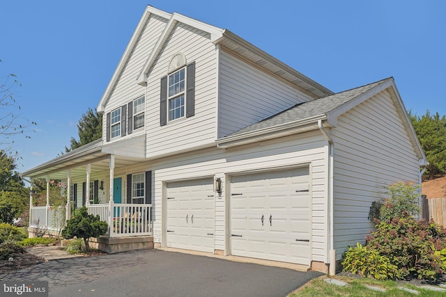 traditional-style house featuring covered porch and driveway