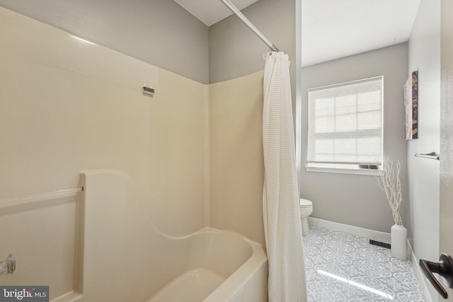 bathroom with toilet and baseboards