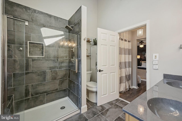 full bath with a stall shower, toilet, and double vanity