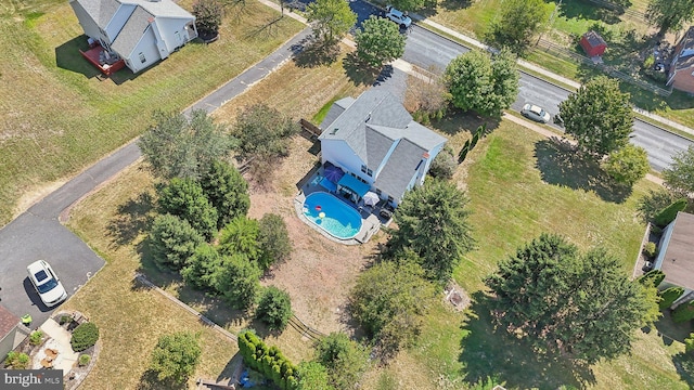 aerial view of property and surrounding area featuring a pool