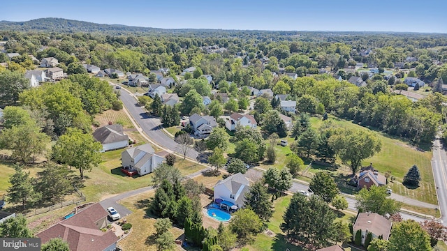 aerial view of property and surrounding area with nearby suburban area