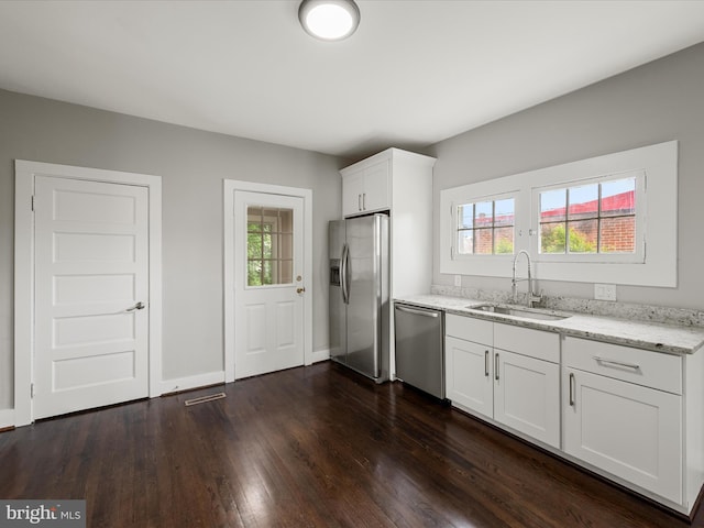 19 W Jackson St, Front Royal, VA 22630 - kitchen with stainless steel appliances, a sink, light stone counters, dark wood-type flooring, and plenty of natural light