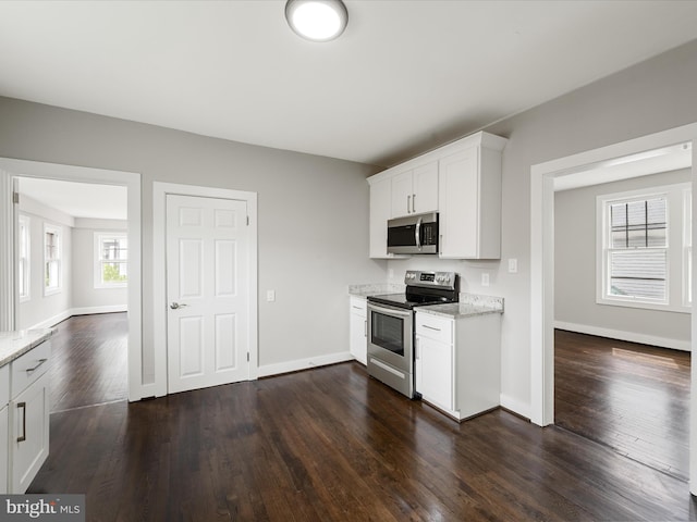 19 W Jackson St, Front Royal, VA 22630 - kitchen with appliances with stainless steel finishes, dark wood-type flooring, light stone countertops, white cabinetry, and baseboards