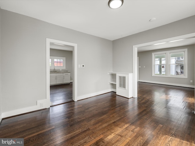 19 W Jackson St, Front Royal, VA 22630 - empty room featuring plenty of natural light, dark wood-style flooring, baseboards, and a sink