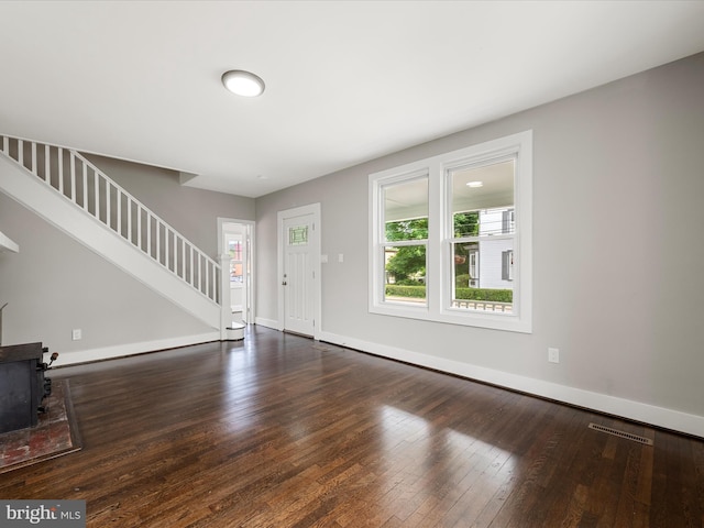19 W Jackson St, Front Royal, VA 22630 - unfurnished living room featuring stairs, healthy amount of natural light, hardwood / wood-style floors, and baseboards