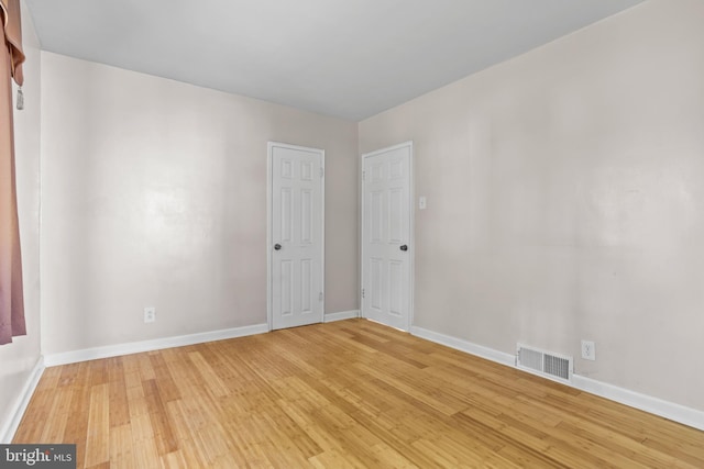 empty room with light wood-type flooring and baseboards
