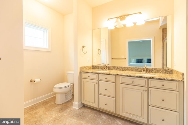 41259 Gloucester Dr, Rehoboth Beach, DE 19971 - bathroom with toilet, baseboards, and double vanity