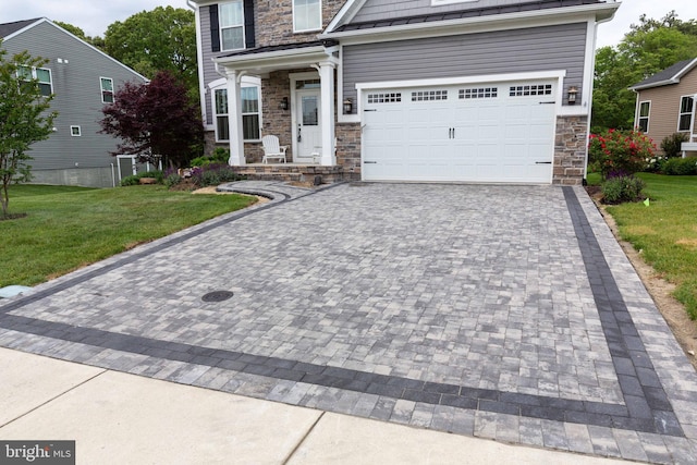 41259 Gloucester Dr, Rehoboth Beach, DE 19971 - view of front of property with stone siding, decorative driveway, a front yard, and a garage
