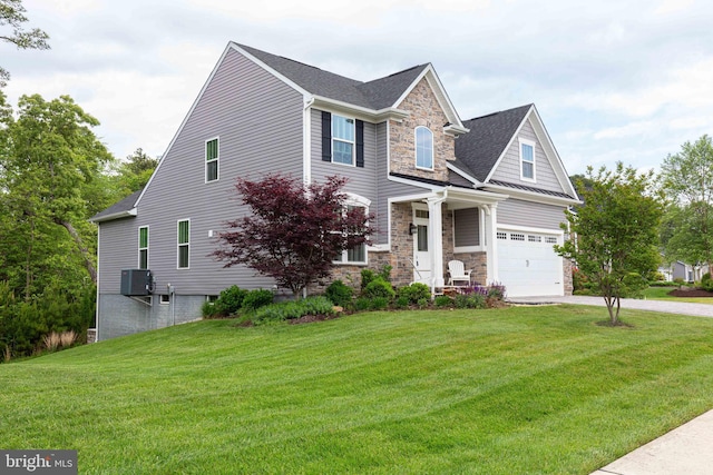 41259 Gloucester Dr, Rehoboth Beach, DE 19971 - view of front facade featuring stone siding, driveway, an attached garage, and a front lawn
