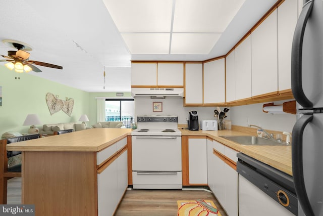 72nd St Unit 35, Ocean City, MD 21842 - kitchen with white appliances, under cabinet range hood, a peninsula, a sink, and light countertops