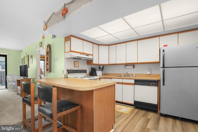72nd St Unit 35, Ocean City, MD 21842 - kitchen with white appliances, a sink, light countertops, a peninsula, and white cabinetry