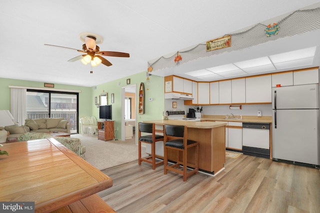 72nd St Unit 35, Ocean City, MD 21842 - kitchen with white appliances, light wood-style flooring, a sink, under cabinet range hood, and open floor plan