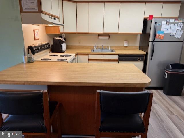 72nd St Unit 35, Ocean City, MD 21842 - kitchen featuring electric range, freestanding refrigerator, under cabinet range hood, white dishwasher, and a sink