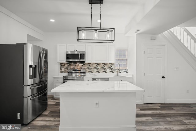 2305 James St, Baltimore, MD 21230 - kitchen with stainless steel appliances, a sink, dark wood finished floors, white cabinets, and recessed lighting