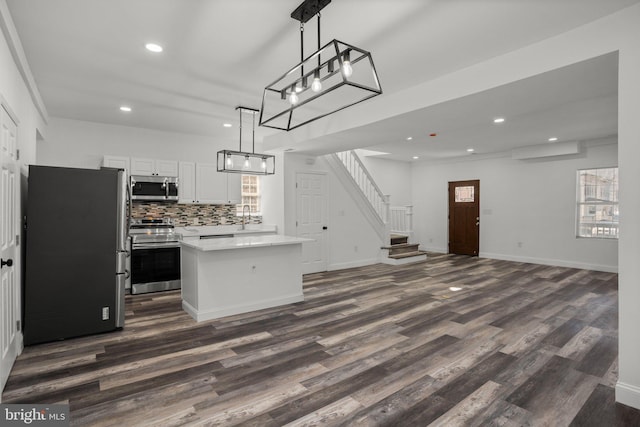 2305 James St, Baltimore, MD 21230 - kitchen featuring stainless steel appliances, dark wood finished floors, a kitchen island, tasteful backsplash, and recessed lighting