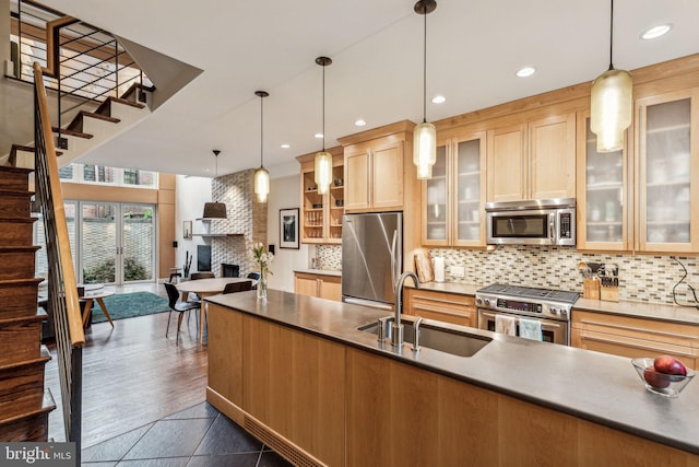 1210 Pine St, Philadelphia, PA 19107 - kitchen featuring stainless steel appliances, a sink, a brick fireplace, tasteful backsplash, and recessed lighting