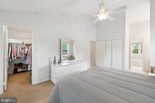 1276 Mason Mill Ct, Herndon, VA 20170 - bedroom featuring a closet, light colored carpet, a walk in closet, high vaulted ceiling, and baseboards