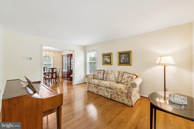 1276 Mason Mill Ct, Herndon, VA 20170 - living area with a chandelier, wood finished floors, and baseboards