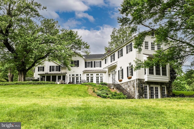 1435 Hunter View Farms, Vienna, VA 22182 - rear view of property with french doors, stone siding, stairs, and a lawn