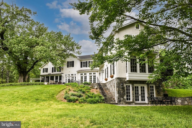 1435 Hunter View Farms, Vienna, VA 22182 - rear view of property featuring french doors, stone siding, stucco siding, a lawn, and stairway