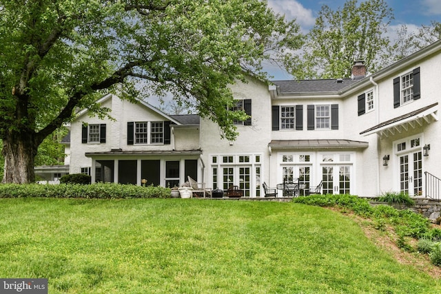 1435 Hunter View Farms, Vienna, VA 22182 - back of house featuring french doors, a lawn, a standing seam roof, and a chimney