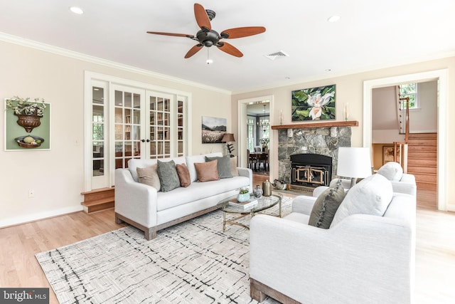 1435 Hunter View Farms, Vienna, VA 22182 - living room with french doors, ornamental molding, light wood-style floors, ceiling fan, and stairs
