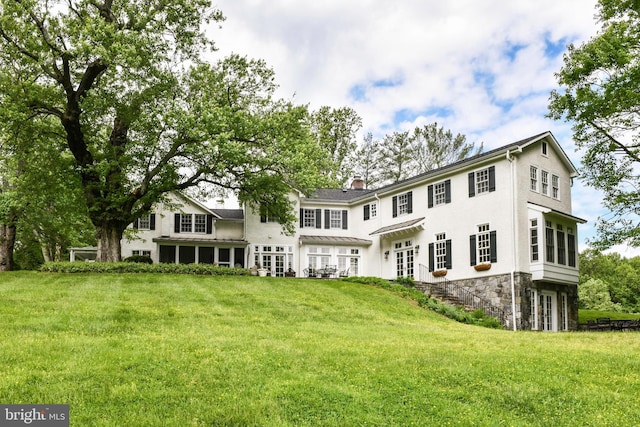 1435 Hunter View Farms, Vienna, VA 22182 - back of property with a yard, a chimney, stone siding, and french doors