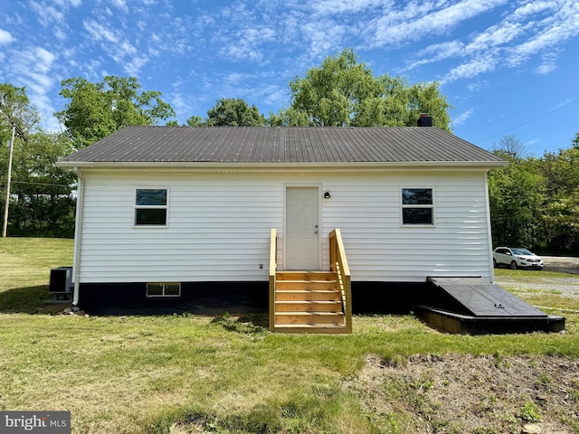 20 Flying Dove Ln, Hedgesville, WV 25427 - rear view of house with entry steps, metal roof, a yard, and a chimney