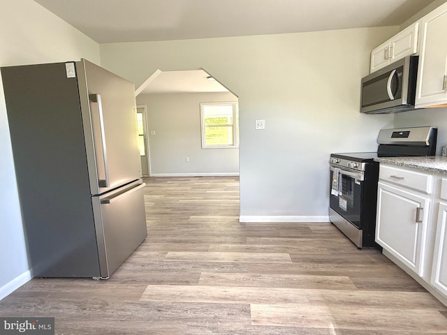 20 Flying Dove Ln, Hedgesville, WV 25427 - kitchen with appliances with stainless steel finishes, white cabinetry, light wood-style floors, and baseboards