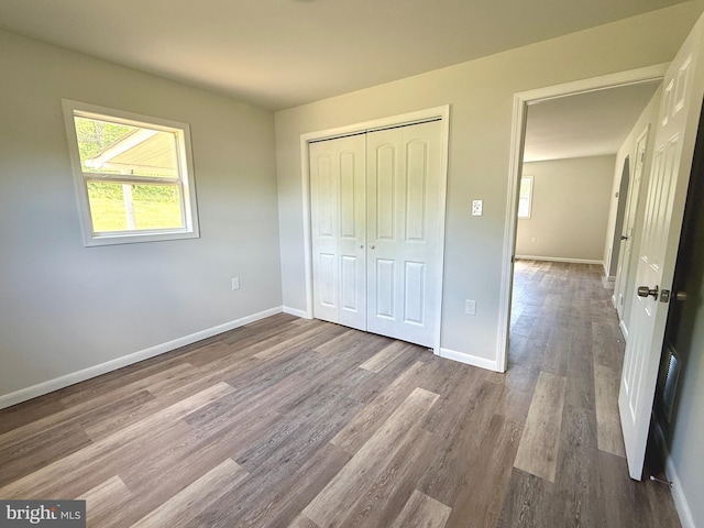 20 Flying Dove Ln, Hedgesville, WV 25427 - unfurnished bedroom featuring wood finished floors, a closet, and baseboards