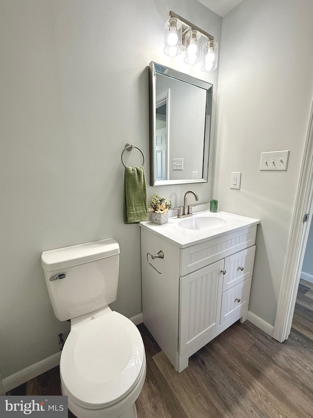20 Flying Dove Ln, Hedgesville, WV 25427 - half bathroom featuring wood finished floors, baseboards, vanity, and toilet