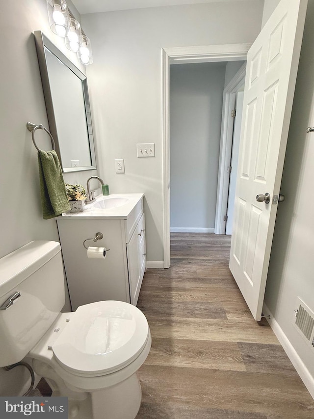 20 Flying Dove Ln, Hedgesville, WV 25427 - bathroom with toilet, wood finished floors, vanity, and baseboards