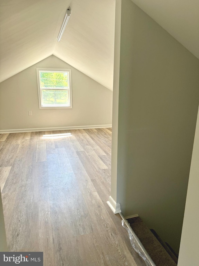 20 Flying Dove Ln, Hedgesville, WV 25427 - additional living space with wood finished floors, vaulted ceiling, and baseboards
