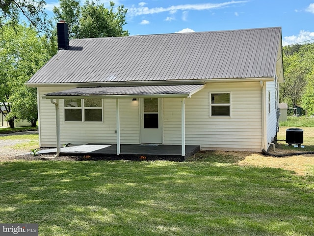20 Flying Dove Ln, Hedgesville, WV 25427 - rear view of property with a lawn, a chimney, metal roof, and cooling unit