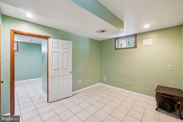 basement featuring light tile patterned flooring, recessed lighting, and baseboards