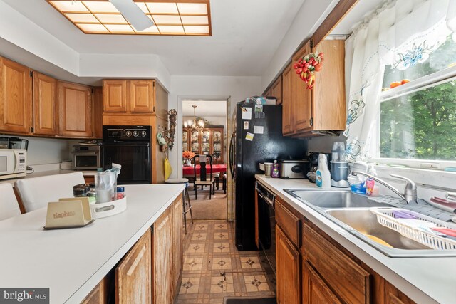 2407 Rochelle Dr, Fallston, MD 21047 - kitchen featuring black appliances, a sink, light floors, and light countertops