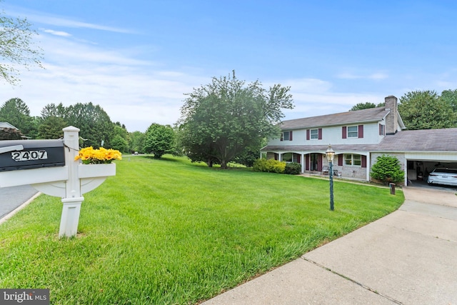 2407 Rochelle Dr, Fallston, MD 21047 - view of front facade with a front yard, concrete driveway, and a chimney